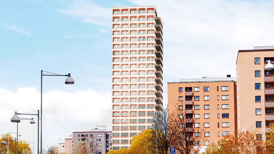 En bilväg bredvid flera höga flerbostadshus.